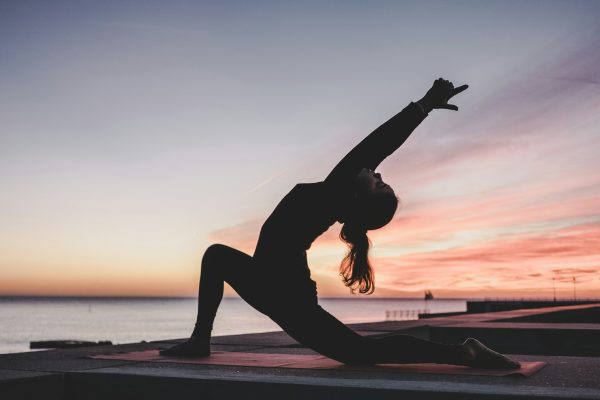 silhouette photography of woman doing yoga